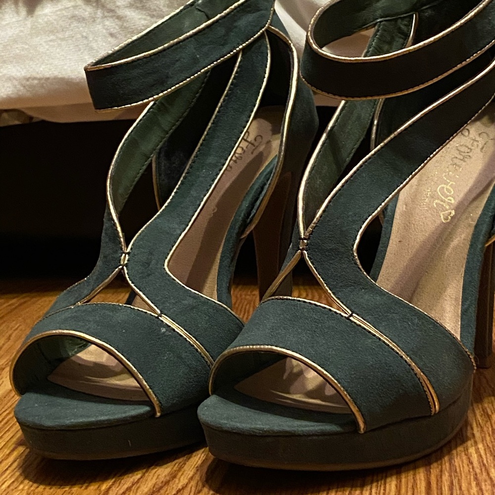 Hunter green heels with gold trim.